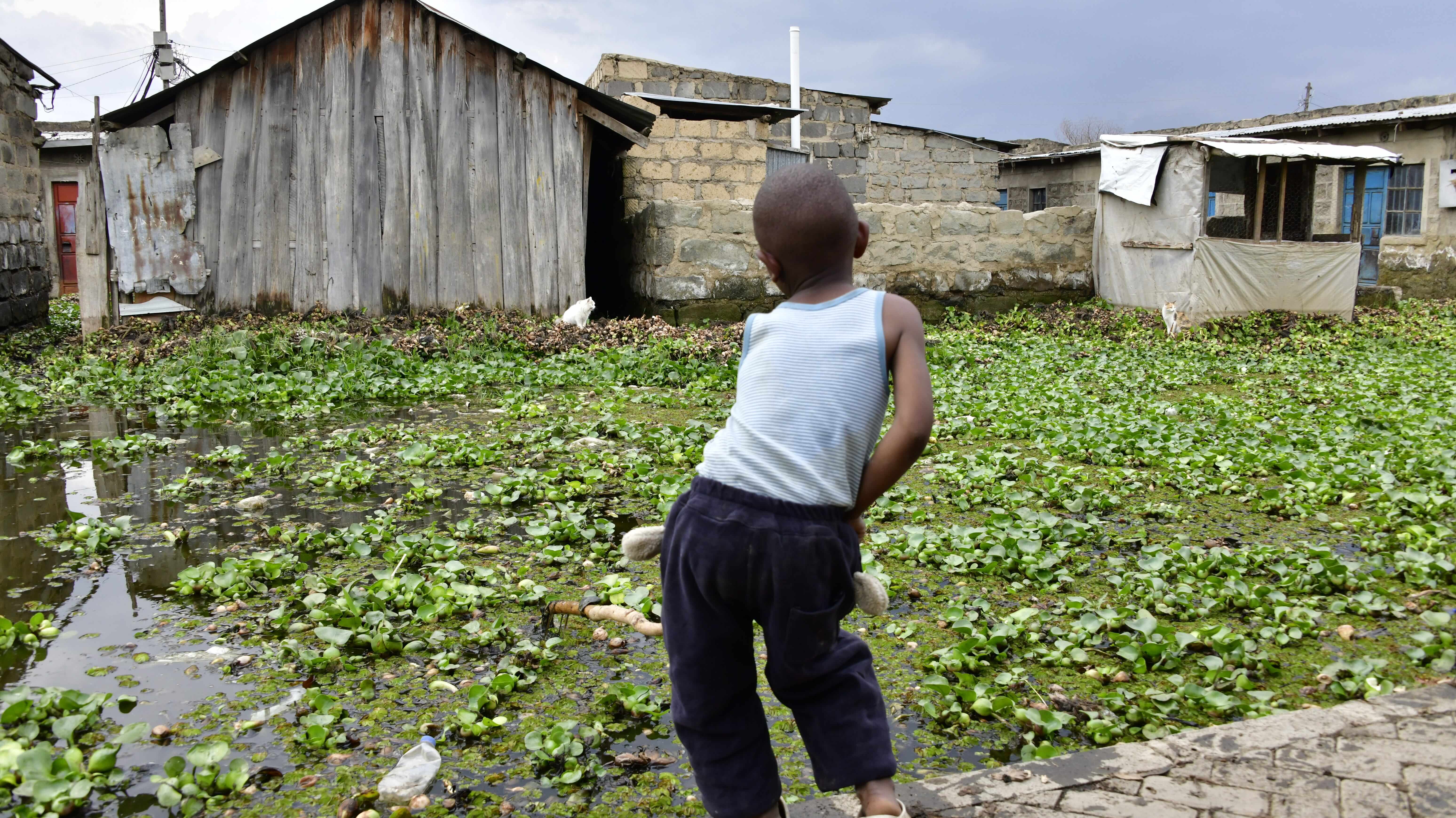 A child plays with dirty and stagnant water at Kihoto, Naivasha. The rising waters of Lake Naivasha has resulted to flooding and submerging of property. Photo taken on July 13,2026.