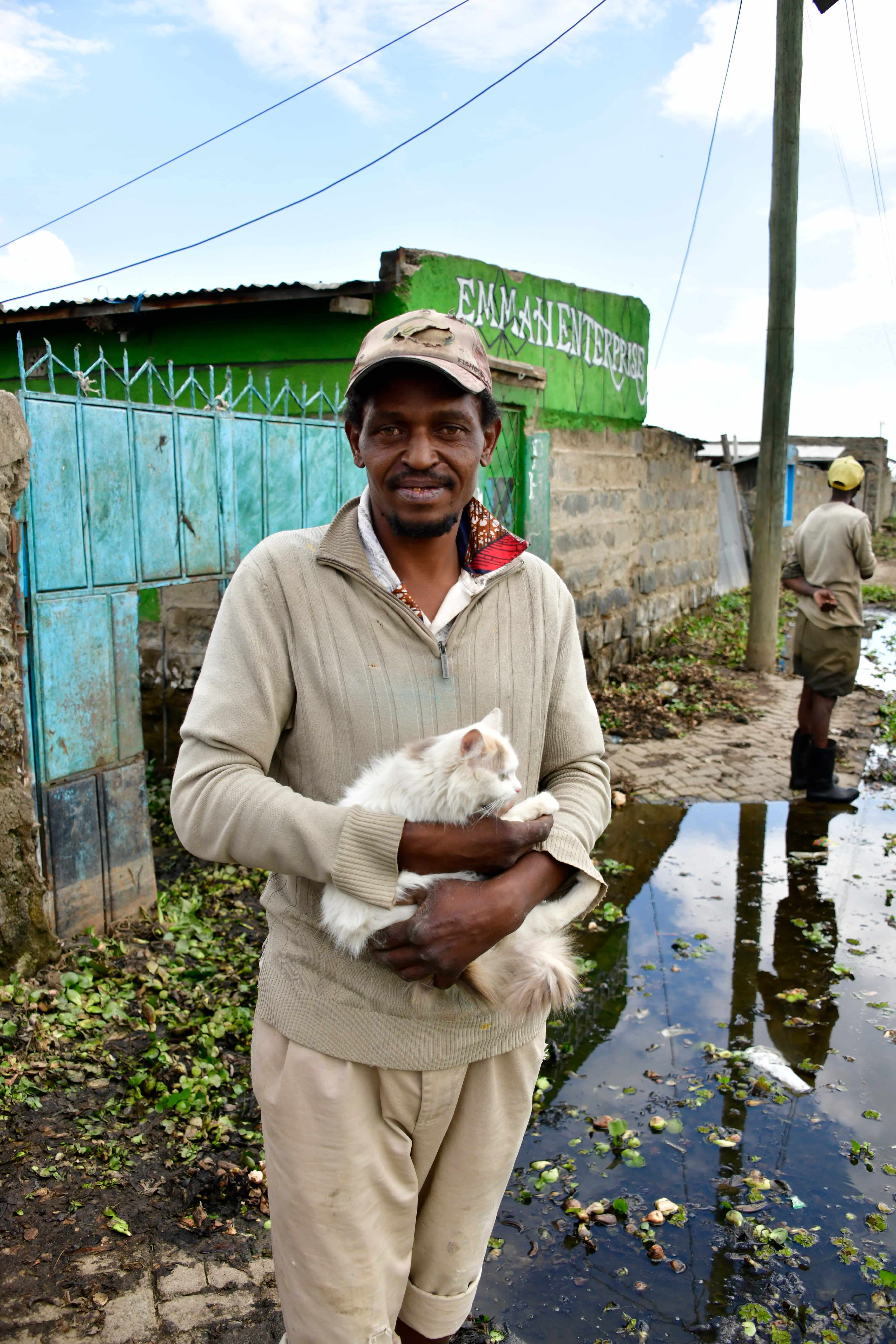 David Njenga, a resident of Kihoto holds his cat. His house has been flooded as a result of the rising waters of Lake Naivasha. Photo taken on July 13,2026.